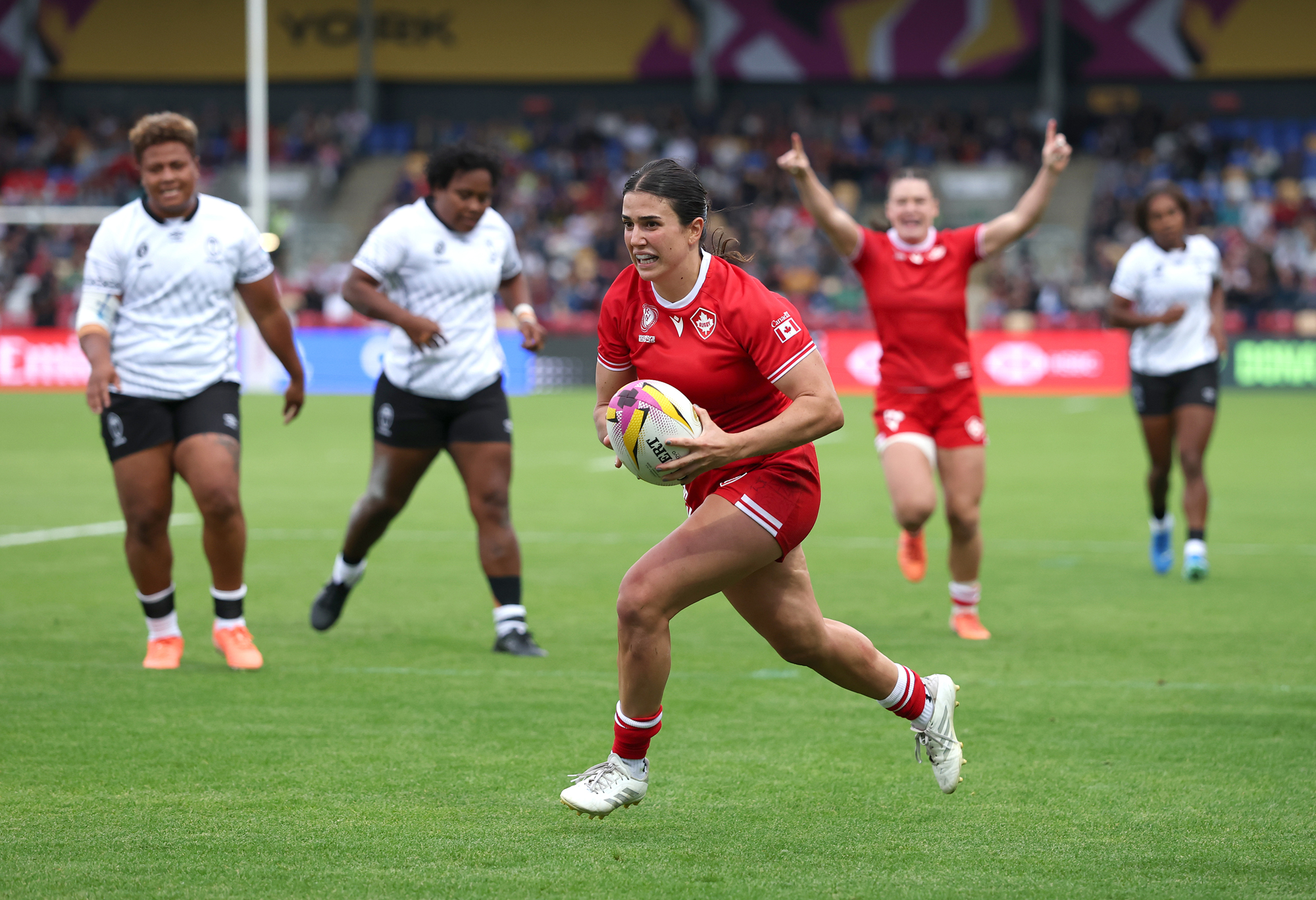 Julia Schell on her way to scoring her fifth try in Canada